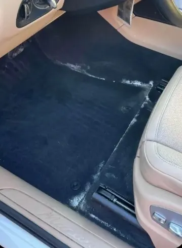 Tapis automobile avant shampoing — dépôts de sel visibles